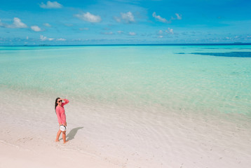 Fototapeta na wymiar Beautiful woman relaxing at white sand tropical beach