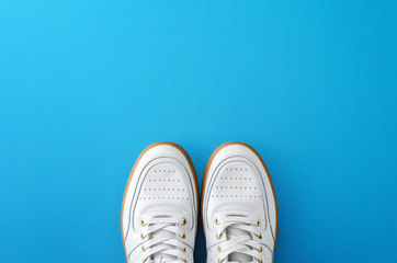 White sneakers with pastel blue background