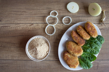 Fried beef cutlet on plate with onion and salat