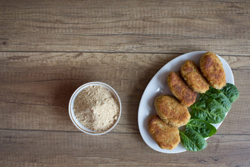 Tasty roasted meat on plate on wooden table