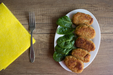 Delicious cutlets with spinach on white plate