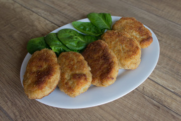 Fried beef cutlet with fork on the plate