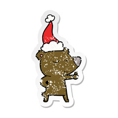 happy distressed sticker cartoon of a bear giving thumbs up wearing santa hat