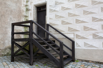 Wooden staircase at the street with paving stones. Copy space