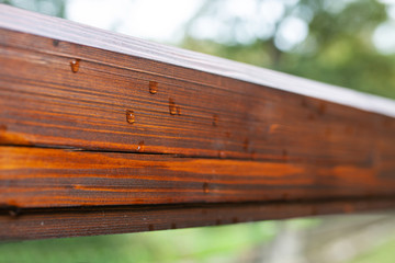 Raindrops on a wooden handrail