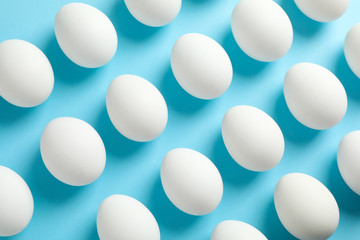 Flat lay composition with chicken eggs on color background, space for text