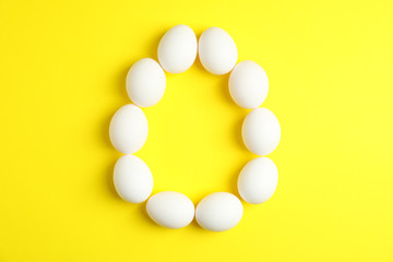 Flat lay composition with chicken eggs on color  background, space for text