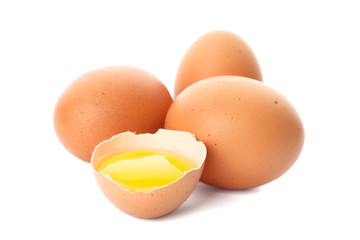 Chicken eggs and half yolk isolated on white background