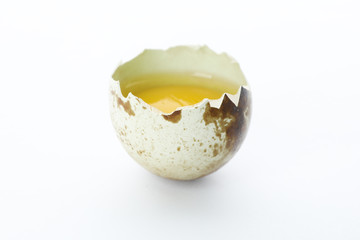 Half raw quail egg isolated on white background