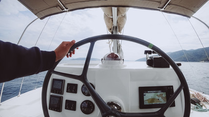 Ship control panel with steering wheel on the captain bridge © teksomolika