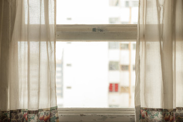 Wooden window with cloth curtains and bright light