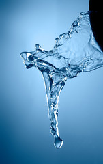 blue color water splash isolated on empty background, studio photo