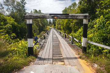 BORNEO / SARAWAK / MALAYSIA / JUNE 2014: Wooden bridge crossing the forest