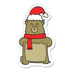 sticker of a cartoon bear wearing christmas hat