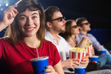 Friends enjoying watching movie at the cinema