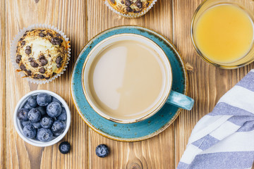 Freshly baked muffins with blueberry on the table.
