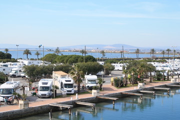Fototapeta na wymiar The Lez, a coastal river, and the motorhome area of in Palavas les flots, a seaside resort of the Languedoc coast in the south of Montpellier