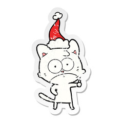distressed sticker cartoon of a nervous cat wearing santa hat