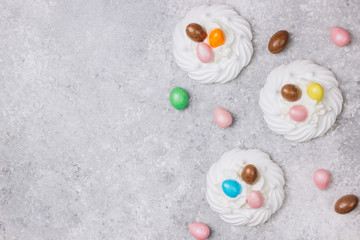 Close-up of pastel colored chocolate Easter egg candy with white meringue