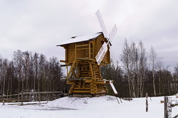 Wooden windmill in the village in the winter