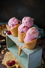 Three waffle cones with pink ice cream