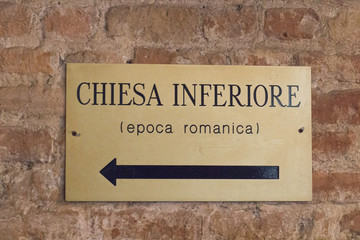 Signpost at the entrance to the lower church San Fermo Maggiore in Verona, Veneto, Italy.