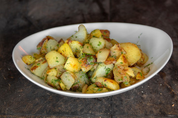 Fresh potatoes with butter and dill baked in a furnace.