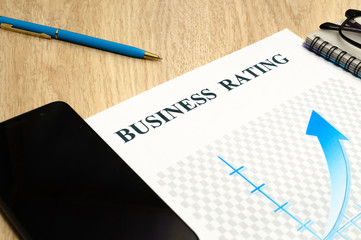 Business financial rating chart with pen, bank cards and calculator.