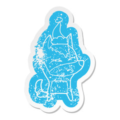 cartoon distressed sticker of a wolf whistling wearing santa hat