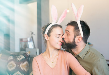 Happy and funny easter day. Beautiful young loving couple wearing rabbit bunny ears costume
