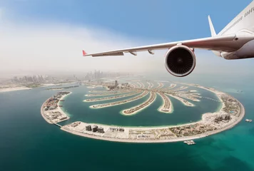 Foto op Canvas Commercial jet plane flying above Dubai city. © Jag_cz