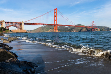Surf in front of Golden Gate Bridge worldwide known symbol of California
