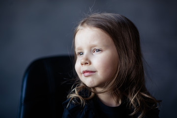 Studio portrait of a girl 4-5 years old on a dark background