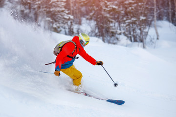 Man athlete mountain skiing rides on soft snow track in woods, chest action camera. Extreme concep