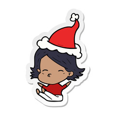 sticker cartoon of a woman sitting wearing santa hat