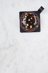 Chocolate cake on a white marble board.