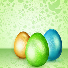 Three colored Easter eggs standing on green background of flowers, cakes, hare, chicken and other holiday symbols