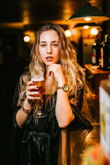 Young woman enjoys a beer