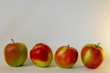 Four red isolated apples on the white background
