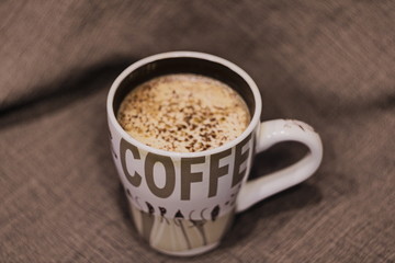 Coffeecup with coffee, chocolate, cinnamon and milk