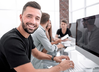 Fototapeta premium Office workers gather around a table to do research and implement new ideas