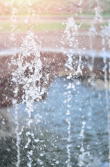 Splash water from fountain as an abstract background. Shallow depth of field, close-up.