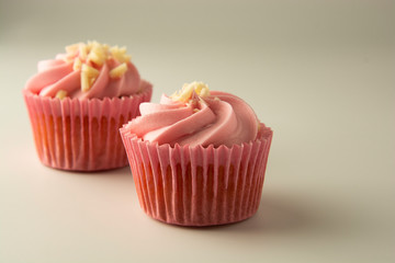 Close up pink, strawbery, fruit cupcakes isoalted. Sweet dessert, shortcakes with cream. Birthday food, cake, muffin. Tempalte for sugar addicted post for social media food content.