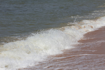 Waves crashing on a sandy beach