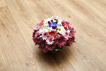 beautiful bouquet from spring flowers on a wooden background