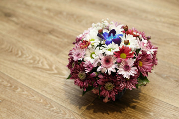 spring bouquet of flowers. wooden background. top view