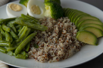 Salad bowl with quinoa and green vegetables - green peas, avocado, broccoli and eggs. Healthy food, green salad palte.
