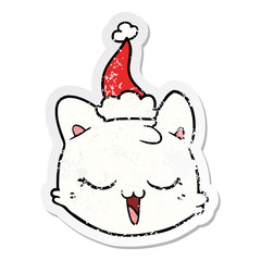 distressed sticker cartoon of a cat face wearing santa hat