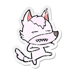 distressed sticker of a cartoon wolf kicking