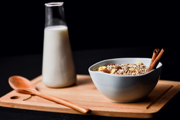 Bowl of breakfast cereals and bottle of milk.